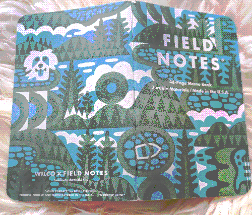 Cover of Field Notes notebook with abstract art of summer imagery including a rowboat and a swimming dog.